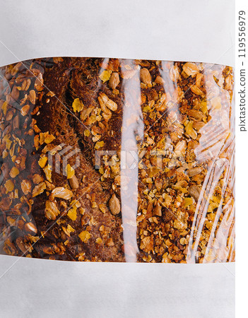 Freshly baked loaf of bread with seeds in paper bag Freshly baked loaf of bread with seeds in paper bag 119556979