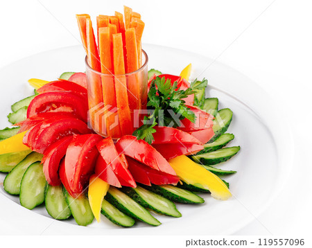 Fresh vegetables arranged on plate forming flower shape with carrots in the middle 119557096
