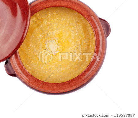Opened clay pot with hot polenta and melting butter inside Opened clay pot with hot polenta and melting butter inside 119557097