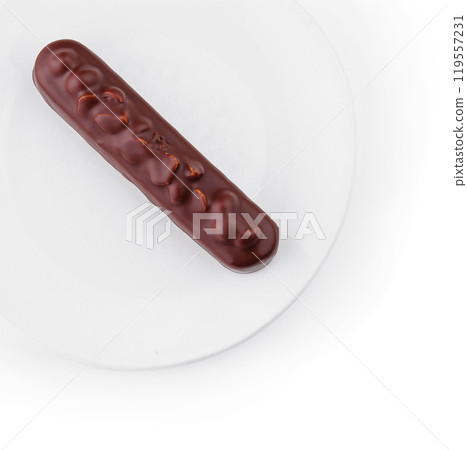 Elegant chocolate Eclair on white plate Elegant chocolate Eclair on white plate 119557231