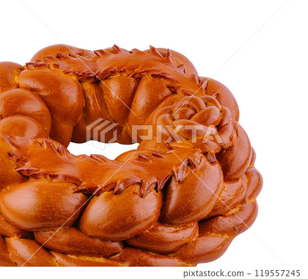 Round loaf of bread decorated with dough flowers baking on white background Round loaf of bread decorated with dough flowers baking on white background 119557245