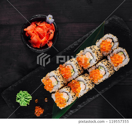 Sushi rolls set served on black stone with ginger and wasabi Sushi rolls set served on black stone with ginger and wasabi 119557355