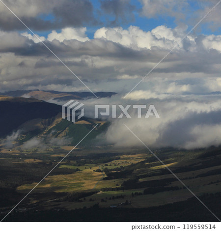 Dramatic clouds over Farmland near Wanaka, New Zealand. 119559514