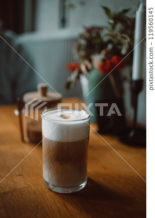 Iced latte coffee in a glass in coffee shop. Cold summer refreshment drink Iced latte coffee in a glass in coffee shop. Cold summer refreshment drink 119560145