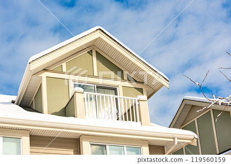 Top of residential house on blue sky background on winter season in Canada 119560159