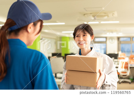 A female engineer in work clothes receiving a parcel 119560765