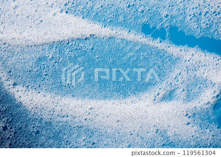 Background and pattern. White soap foam with bubbles, texture on blue tile background. 119561304