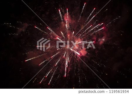 Red explosion of fireworks with smoke and bokeh on a black background. 119561934