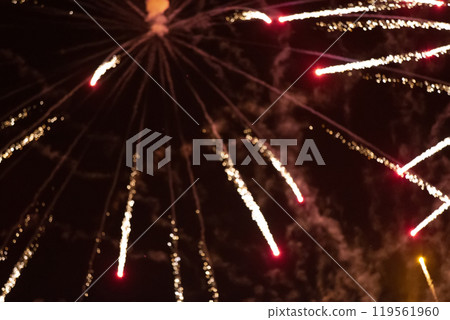 Red rays of fireworks on black background. Festive night background. Red rays of fireworks on black background. Festive night background. 119561960