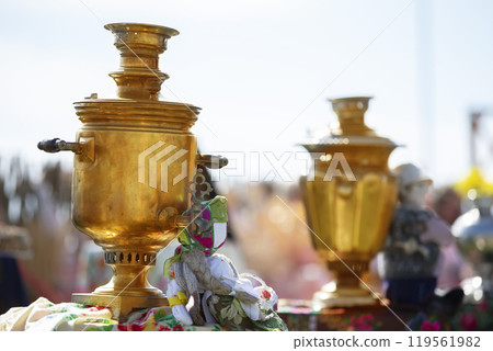 Golden samovars at the festive fair. Old teapot 119561982