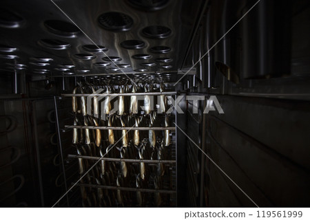 Industrial smoking of fish. Mackerel in a smoking oven. 119561999