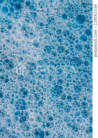 Background and pattern. White soap foam with bubbles, texture on blue tile background. 119562339