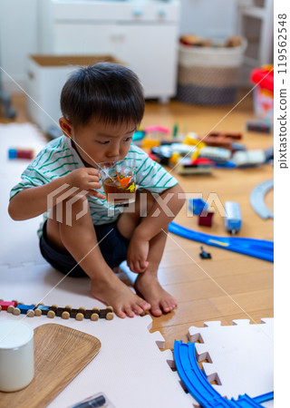 A 2-year-old boy playing with Plarail 119562548