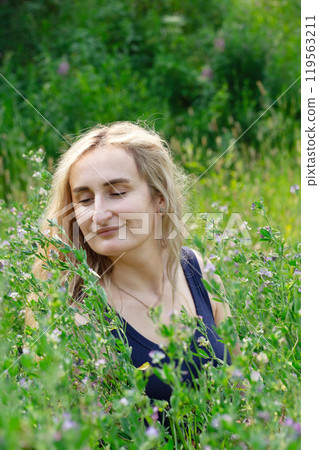 Woman with natural beauty enjoying nature in summer park. Woman with natural beauty enjoying nature in summer park. 119563211