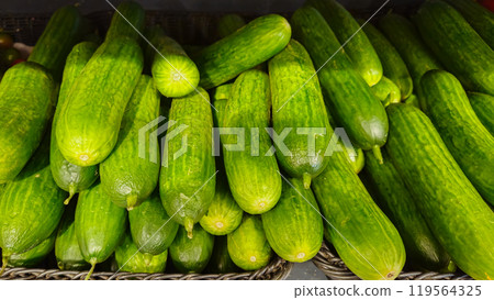 Cucumbers background. Cucumbers on store shelves. Vegetables in the store 119564325