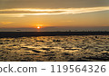 Epic sunset scene on Koh Phangan. The sun's rays illuminate the clouds and the sky is mirrored from the water and sand 119564326