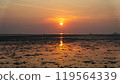 Epic sunset scene on Koh Phangan. The sun's rays illuminate the clouds and the sky is mirrored from the water and sand 119564339