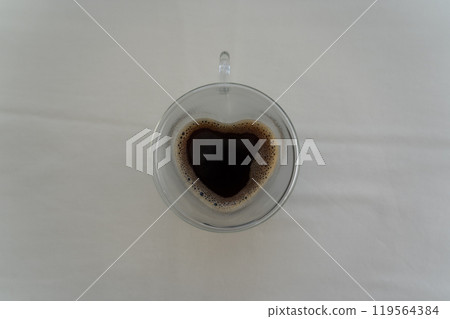 A heart-shaped mug with instant coffee. Coffee background A heart-shaped mug with instant coffee. Coffee background 119564384