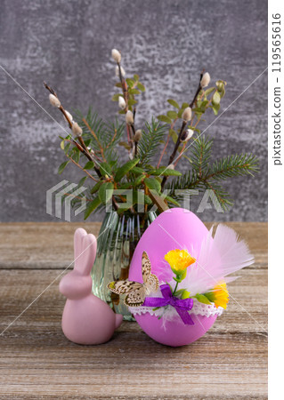 Wooden table with Easter bunny, egg and bunch of willow. Wooden table with Easter bunny, egg and bunch of willow. 119565616