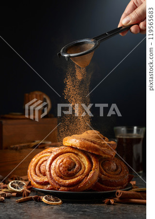 Kanelbullar. Freshly baked buns sprinkled with cinnamon. Kanelbullar. Freshly baked buns sprinkled with cinnamon. 119565683