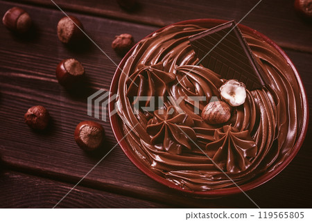 Chocolate nut paste, mousse, pasta, in a cup, on a wooden table, top view, selective focus, no people, Chocolate nut paste, mousse, pasta, in a cup, on a wooden table, top view, selective focus, no people, 119565805