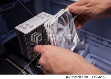 Cleaning a processor fan with a brush 119565828