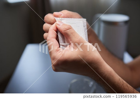 brewing process,a bag filled with boiling water for drip coffee in a cup,top view. 119565936