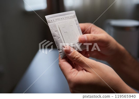 brewing process,a bag filled with boiling water for drip coffee in a cup,top view. 119565940