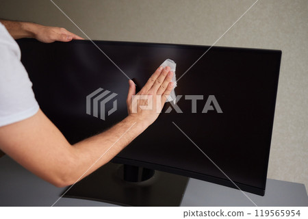 cleaning pc monitor an hand hold a rag cleaning pc monitor an hand hold a rag 119565954