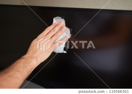 cleaning pc monitor an hand hold a rag cleaning pc monitor an hand hold a rag 119566301