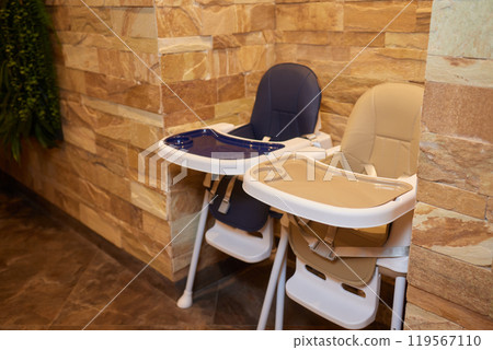 A view looking down wooden child high chairs, in a restaurant setting. A view looking down wooden child high chairs, in a restaurant setting. 119567110