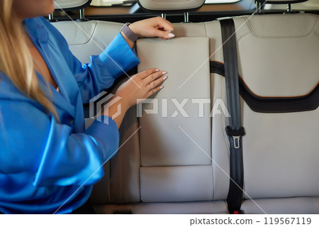 female hand opens the Cup holder in the car 119567119