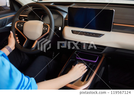Hand of woman holding steering wheel of car Hand of woman holding steering wheel of car 119567124