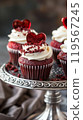 Red Velvet Cupcakes with Cream Cheese Frosting, Red Velvet Crumbs, and Chocolate Heart on a Silver Stand 119567245