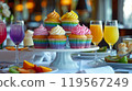 Cozy Restaurant Table with Rainbow-Themed Cupcakes on a Pristine White Platter 119567249