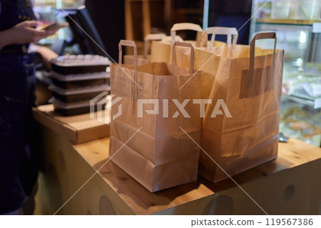 Row of craft paper bags on counter in wood and building supplies store Row of craft paper bags on counter in wood and building supplies store 119567386