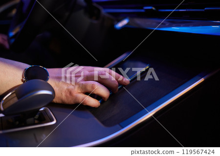 Selector automatic transmission with leather in the interior of a modern expensive car. The background is blurred. Black and brown leather car. Selector automatic transmission with leather in the interior of a modern expensive car. The background is blurred. Black and brown leather car. 119567424