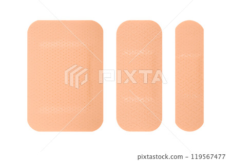 Three different sizes of skin toned adhesive bandages arranged side by side. The bandages have a perforated texture 119567477