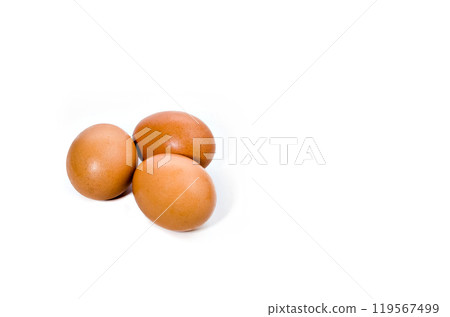 Three fresh eggs on a white background. Copy space 119567499
