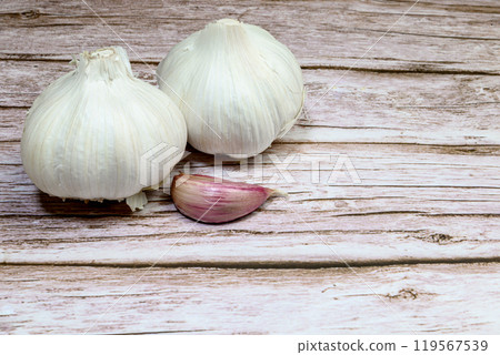 Fresh garlic on a rustic wooden table. Garlic cloves Fresh garlic on a rustic wooden table. Garlic cloves 119567539