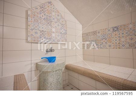 Azure and white textile floor with bench in brick building 119567595