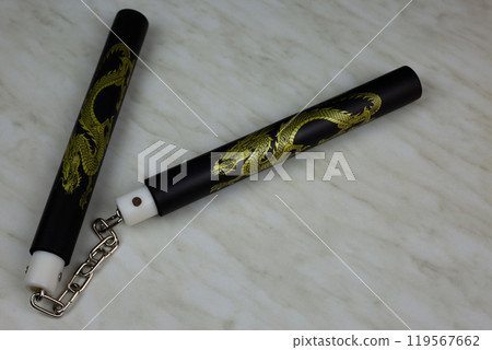 Soft foam rubber training nunchucks with steel chain, training martial arts at home using edged weapons, nunchucks for self defense training on white background 119567662