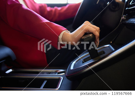 Selector automatic transmission with leather in the interior of a modern expensive car. The background is blurred. Black and brown leather car. Selector automatic transmission with leather in the interior of a modern expensive car. The background is blurred. Black and brown leather car. 119567666