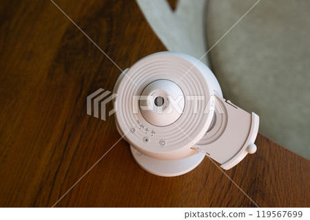 Home galaxy projector with replaceable cartridges with different planets and stars for space exploration at home, projecting the starry sky onto ceiling of room 119567699