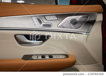 Closeup of car door with brown leather, silver trim Closeup of car door with brown leather, silver trim 119568169