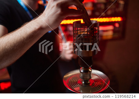 Person holding a hookah at a drinking establishment event Person holding a hookah at a drinking establishment event 119568214