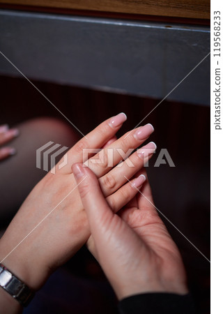 A photo capturing the intimacy and affection in two hands holding closely together 119568233