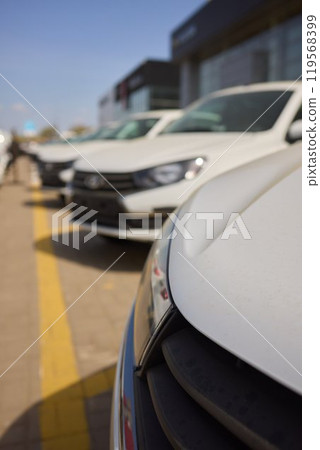 Car Sales and Loan Industry Concept. Row of Brand New Vehicles in Stock. 119568399