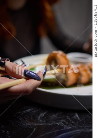 Sushi dish on white plate with sauce, table setting 119568413