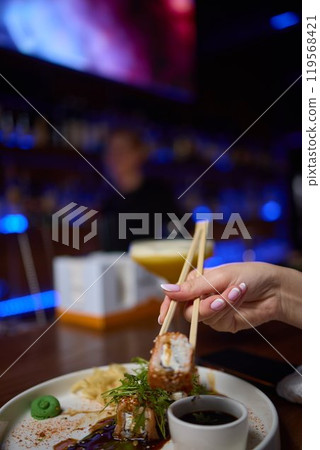 Sushi dish on white plate with sauce, table setting 119568421